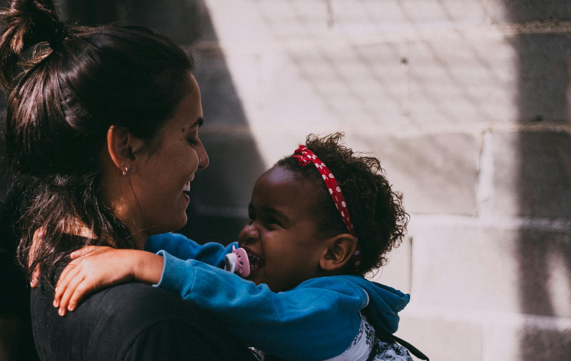 Childcare provider holding a baby